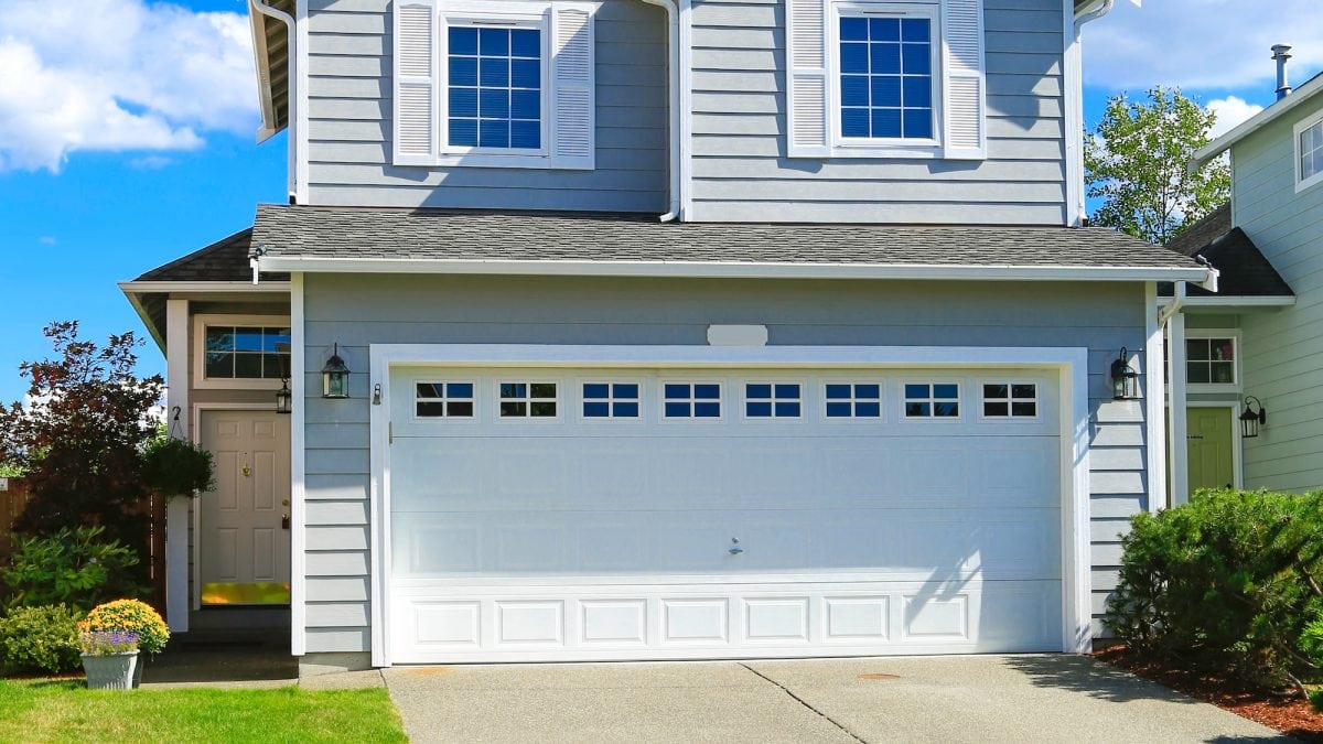 Two story house with small entrance porch and garage with driveway in Urbana, MD.